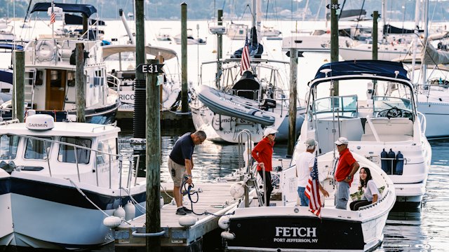 Crew washing boats at a marina dock