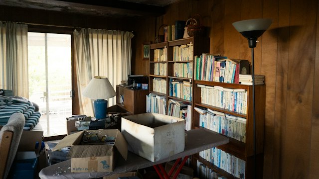 Cluttered room with stacked belongings