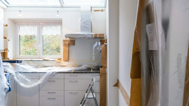 Kitchen under renovation with covered cabinets